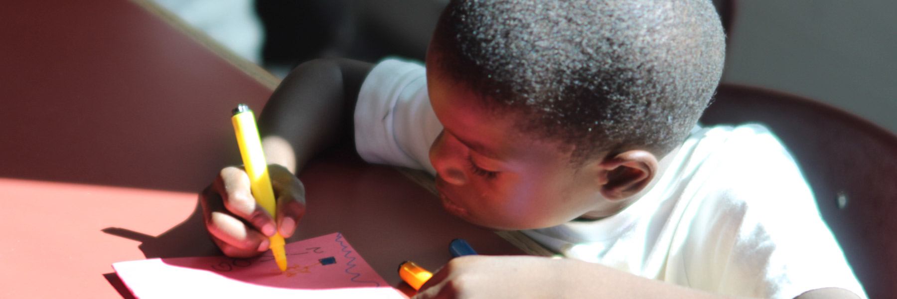 boy coloring with markers